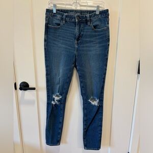 AE High rise skinny jeans with distressing at the knee